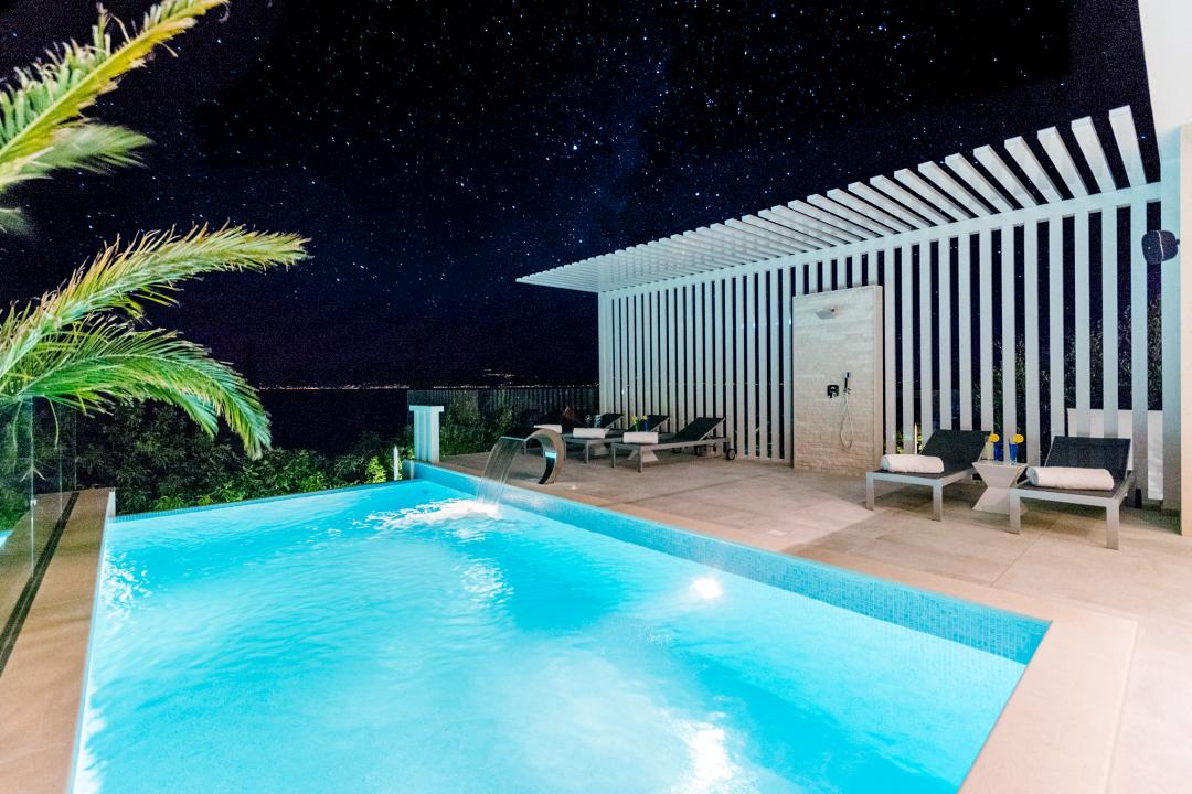 The pool at night with a view on the coast